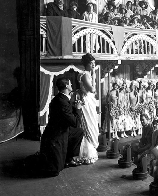 Black and white historical image of two actors on stage